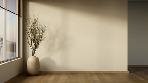 Modern minimalist interior featuring a ceramic vase with dried branches placed beside a window, warm natural sunlight casts soft shadows across a textured wall