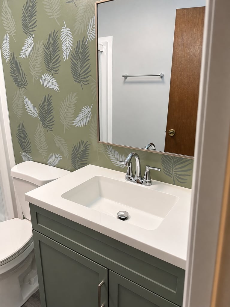 Refined sage bathroom vanity with white double sink, fern-patterned shower curtain, and green cabinet storage